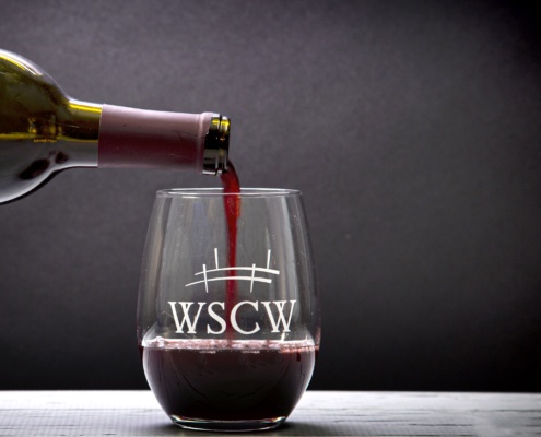 wine being poured into a glass at a winery