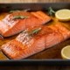 Salmon dinner in a pan with lemons and sage