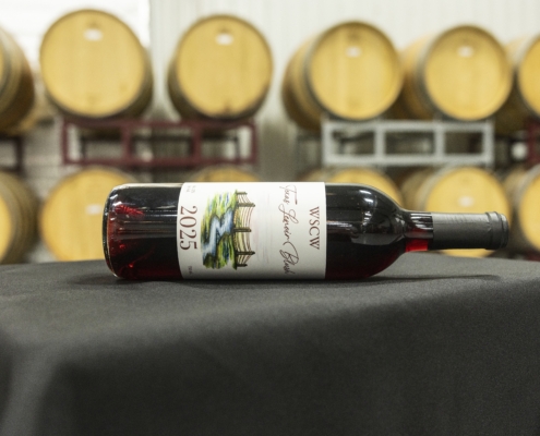 West Sandy Creek winery red wine bottle, 2025 Texas Lenoir Blush, on a table.